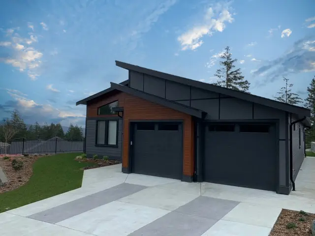 An angular single family residential home with dark cherry FastPlank cladding, and black anodized EasyTrim